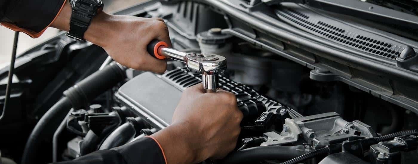 A mechanic is repairing a vehicle's engine.