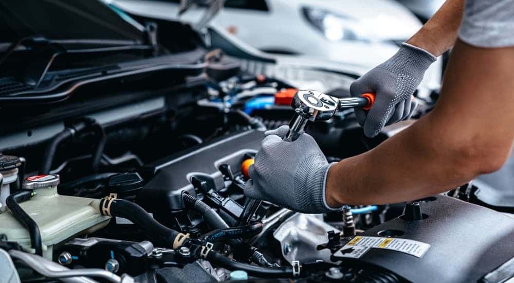 A mechanic performing a repair on a car engine.