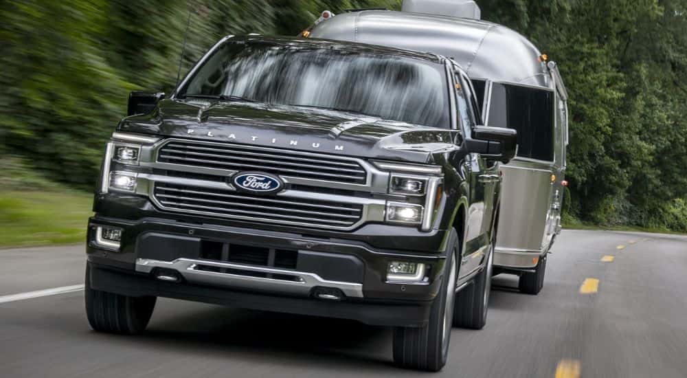 Head-on view of a black 2024 Ford F-150 Platinum towing an Airstream trailer.