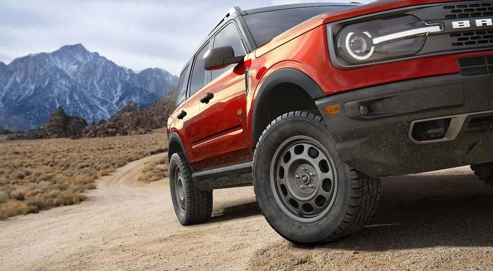 A red 2023 Ford Bronco Sport off-roading on a steep rocky trail.