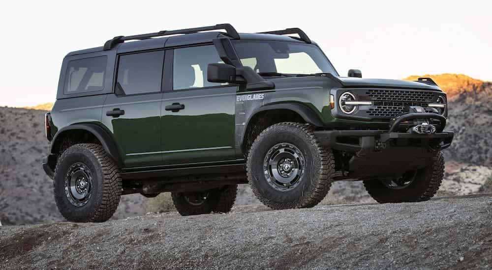 A green 2022 Ford Bronco Everglades is shown from the front at an angle after leaving a used Ford dealer Loganville..