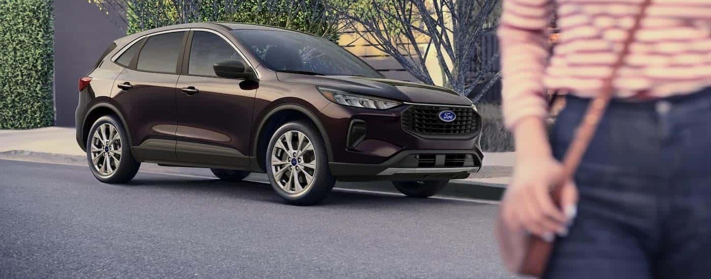 A purple 2023 Ford Escape is shown parked on the side of a street after leaving a Conyers Ford dealer.