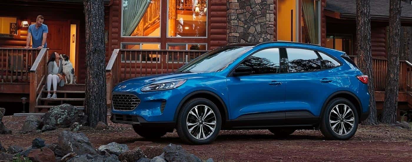 A blue 2021 Ford Escape is shown parked outside of a cabin after leaving a Ford dealer near McDonough.
