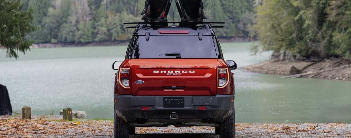 A red 2024 Ford Bronco Sport parked near a lake.