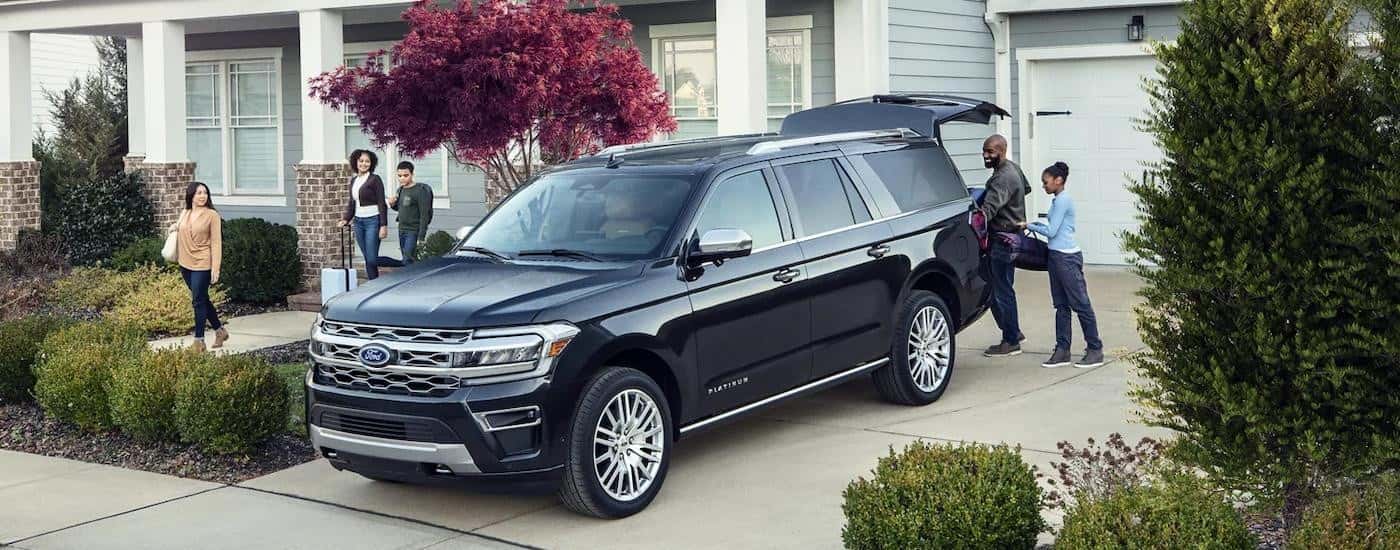 A black 2023 Ford Expedition Platinum is shown parked in a driveway after leaving a Ford dealer near Stockbridge.