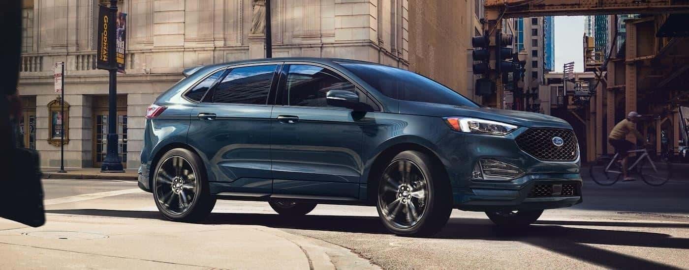 A blue 2024 Ford Edge ST is shown on a test drive at a Ford dealer near Forest Park.