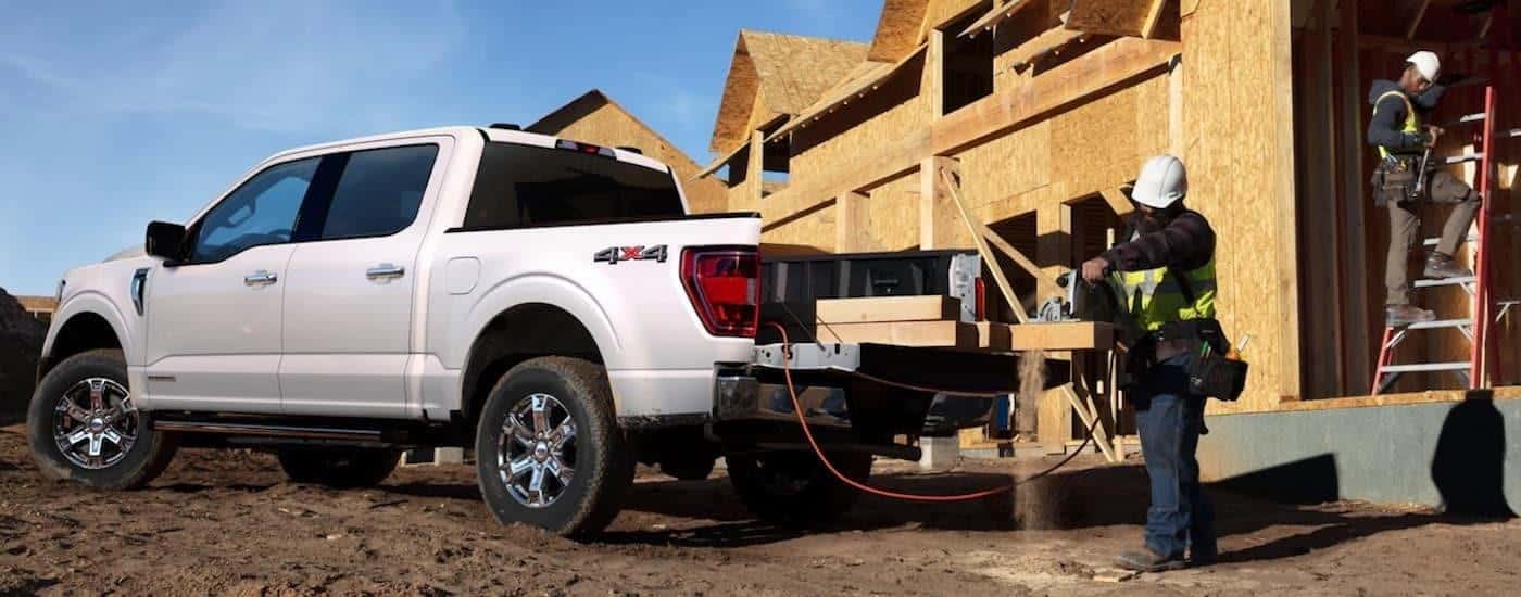 A white 2021 Ford F-150 is shown parked at a construction site after leaving a Ford dealership serving Athens, GA.