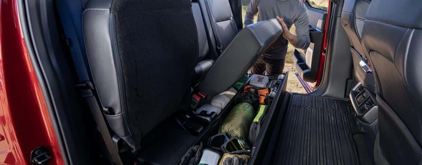 A close up of the under seat storage in a red 2024 Ford F-150.
