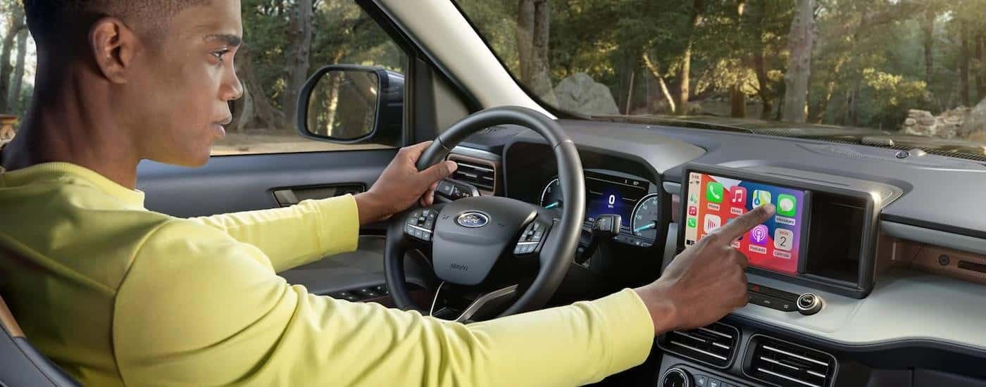 A driver using the infotainment screen in a 2024 Ford Maverick.