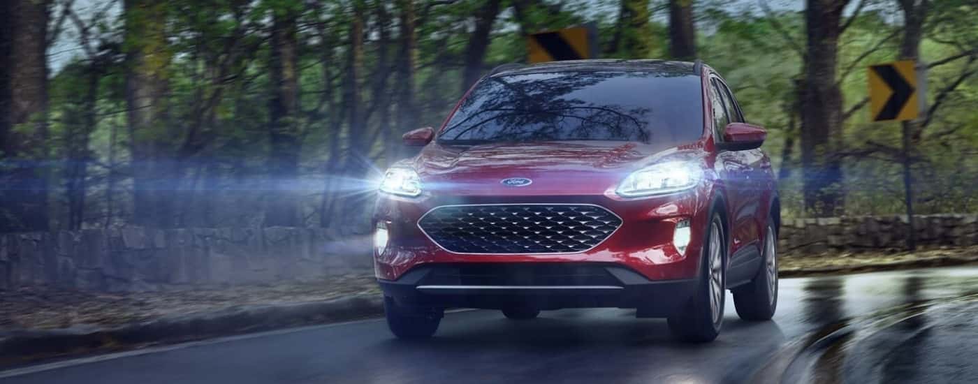 A red 2022 Ford Escape is shown from the front driving at night.