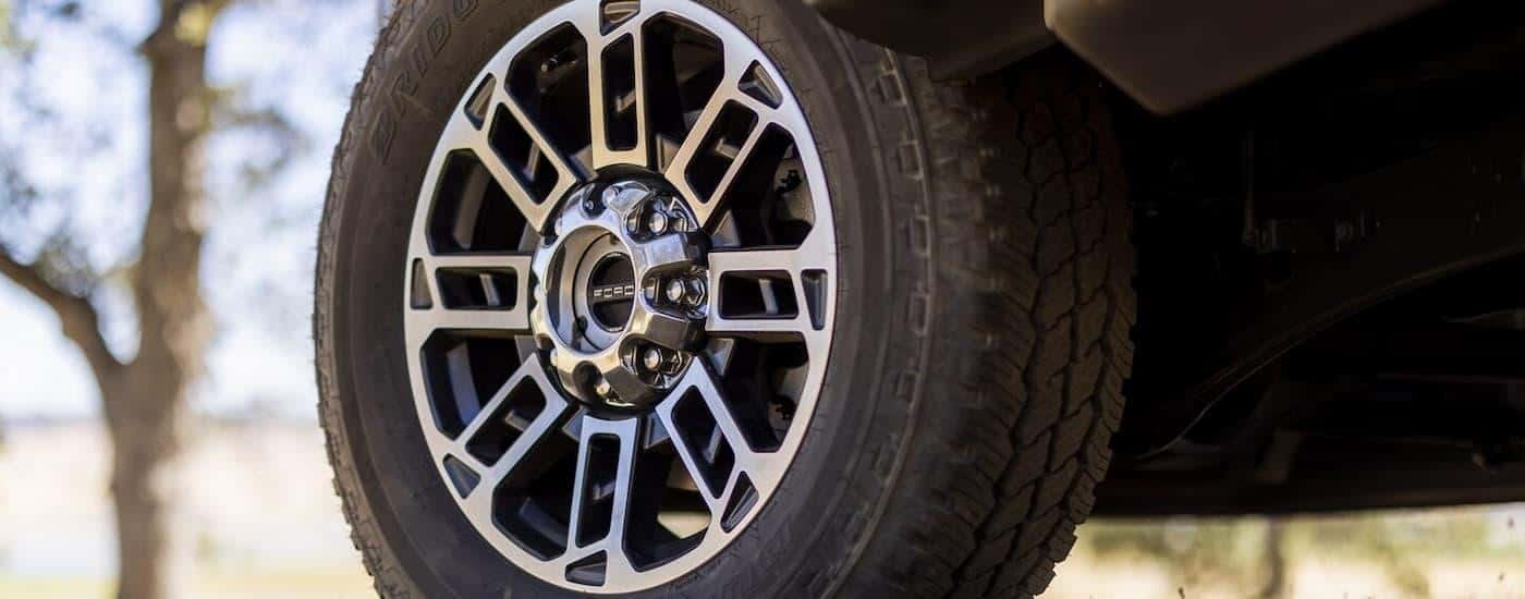 A close up of the silver rim on a 2024 Ford F-450 Super Duty for sale.