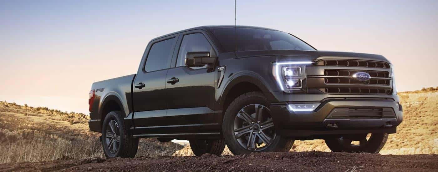 A black 2023 Ford F-150 is shown from the side after leaving a Ford Truck dealer.