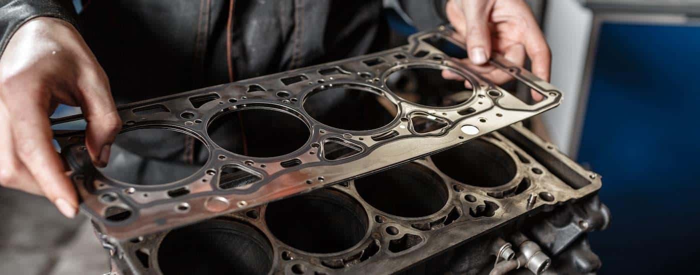 A mechanic is working on a head gasket repair.