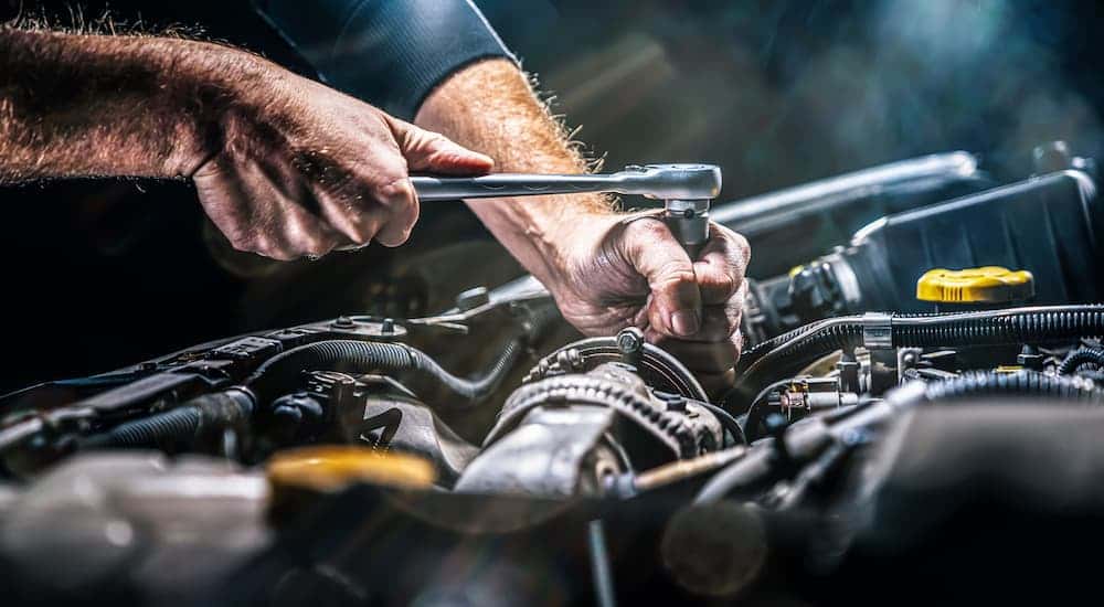 Close-up on a mechanic performing a repair on an engine block.
