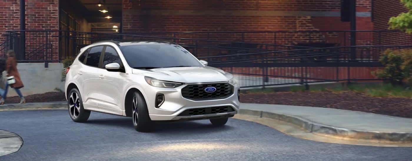 A white 2023 Ford Escape ST-Line is shown after leaving a Monroe Ford dealer.