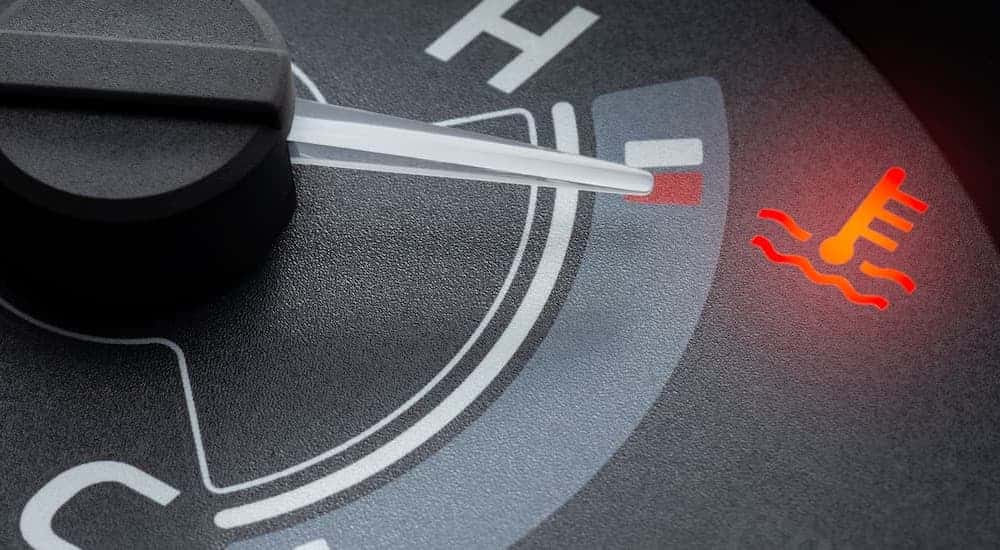 A close up of the temperature gauge on a vehicle that needs a radiator repair.