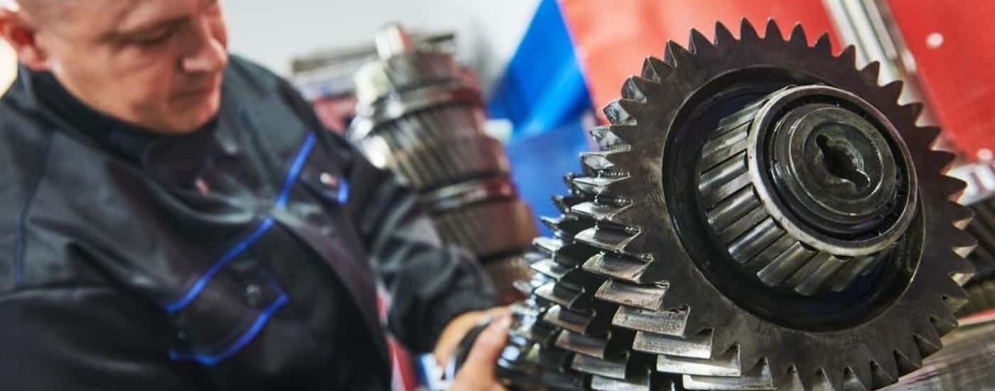 A mechanic is shown during a transmission repair.