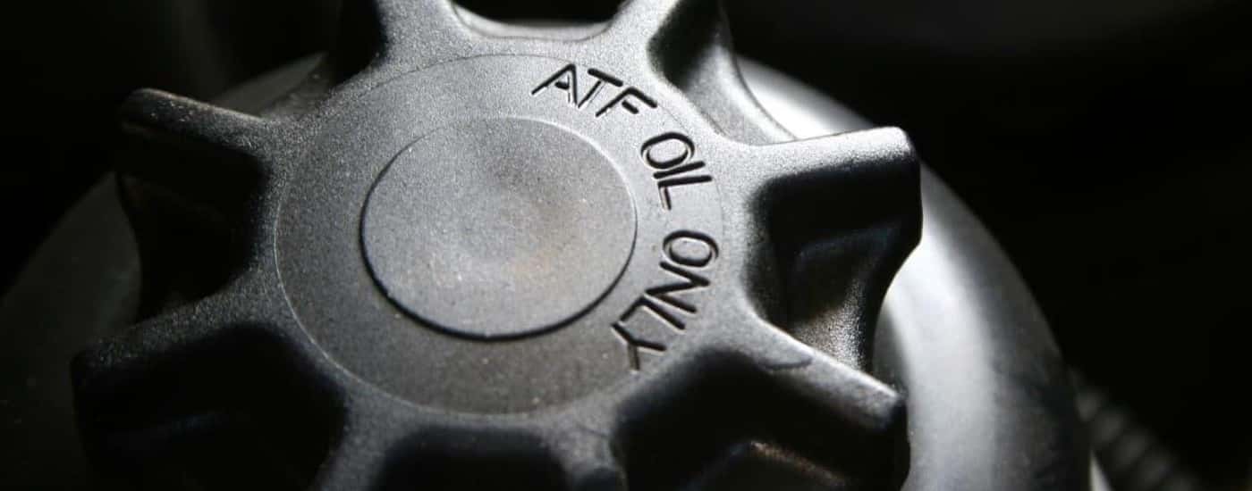 A close up shows the ATF cap on a vehicle.