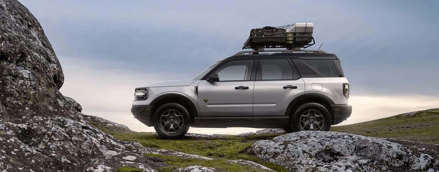 A silver 2022 Ford Bronco Sport is shown from the side parked off-road.