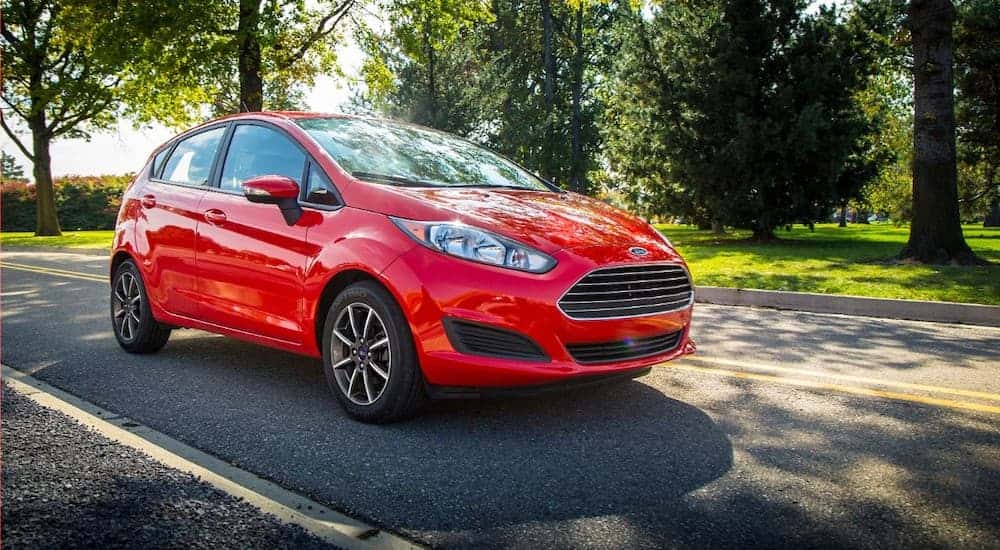 An orange 2015 Ford Fiesta is shown from the front at an angle.