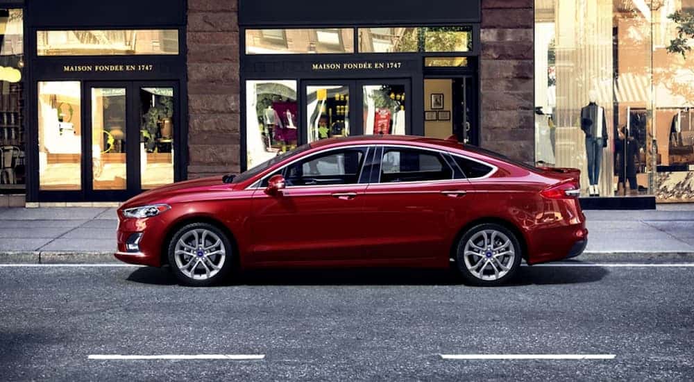 A red 2020 Ford Fusion is shown from the side.