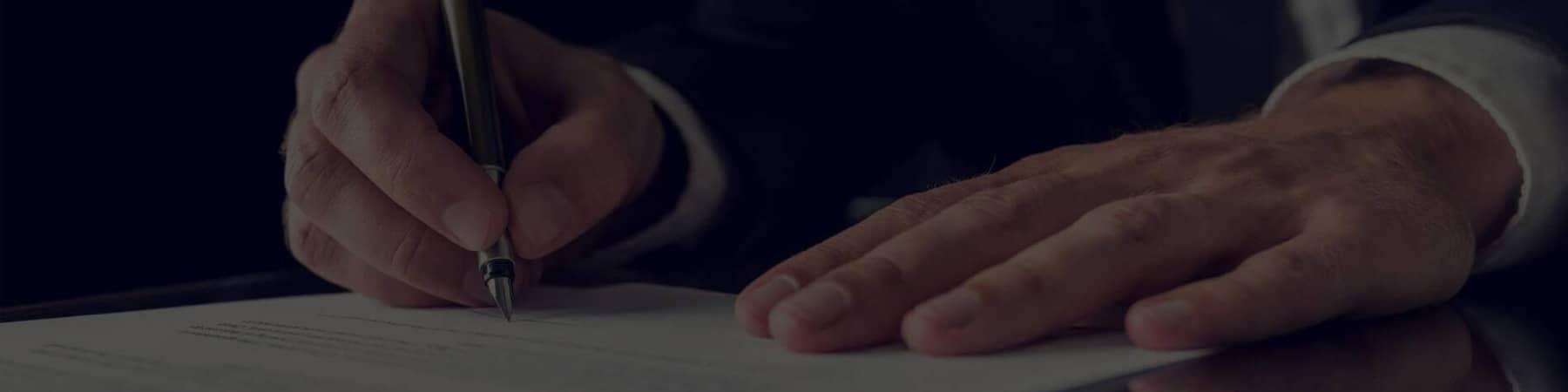 Hands of Man in Suit Signing Document