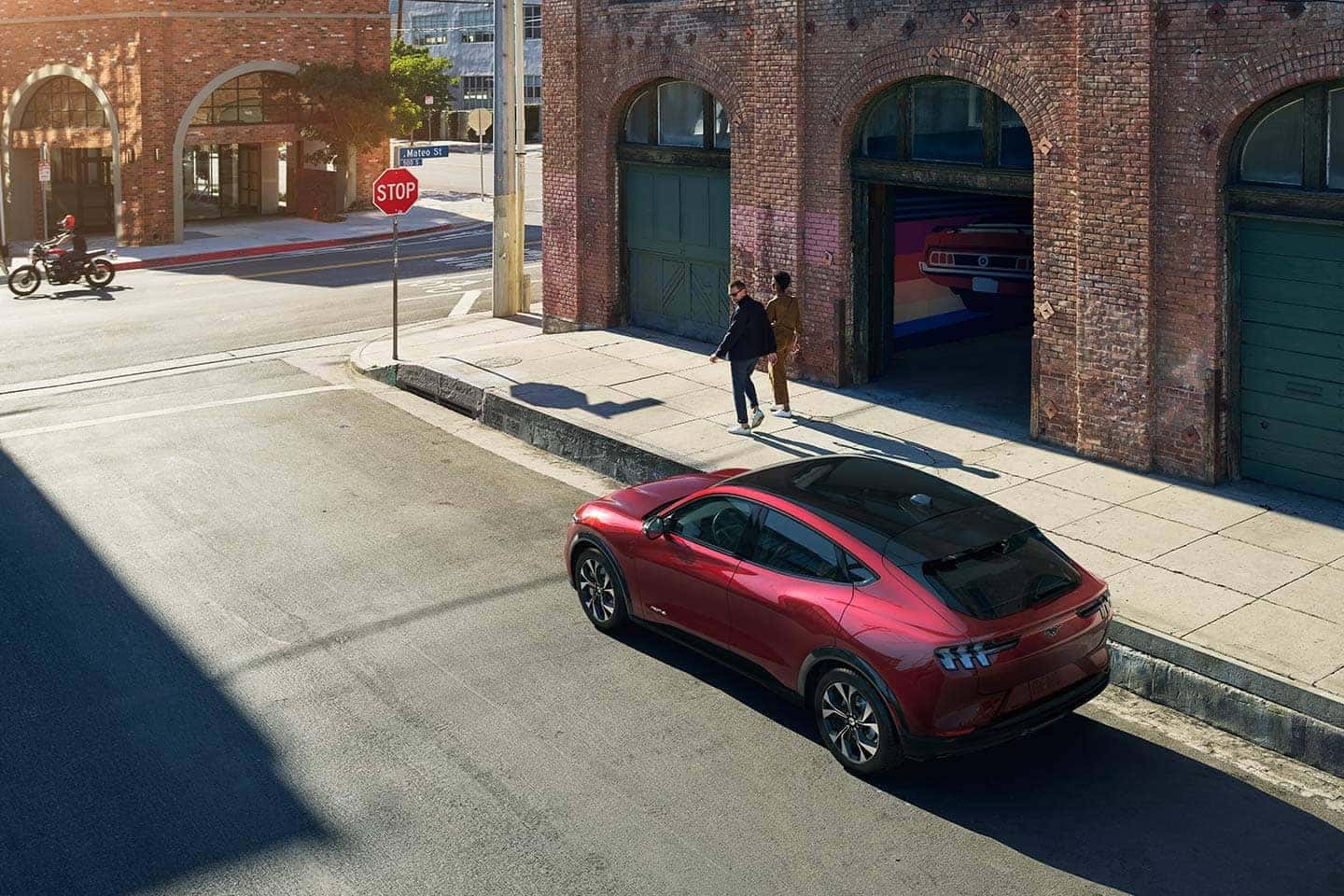 2021 Ford Mach-E parked downtown and man turning around to look at it