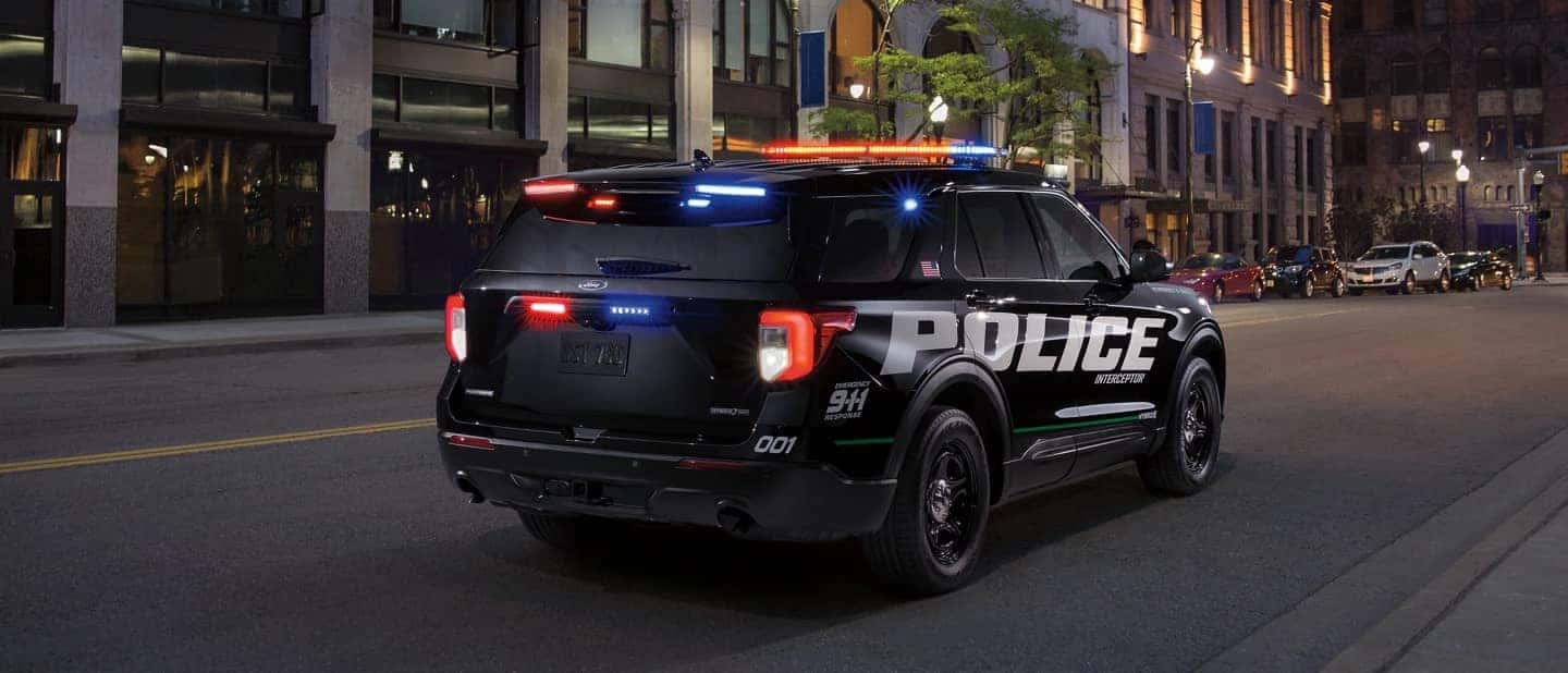2021 Ford Police Utility speeding down street at night