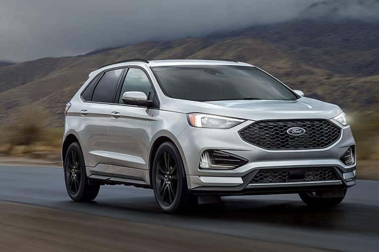 Silver 2021 Ford Edge driving along a foggy mountain pass_mobile