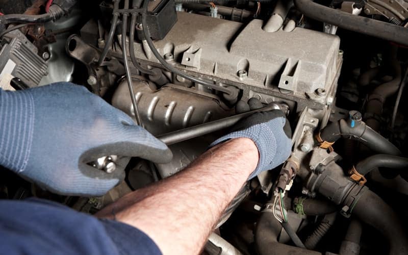 Mechanic repairs a car