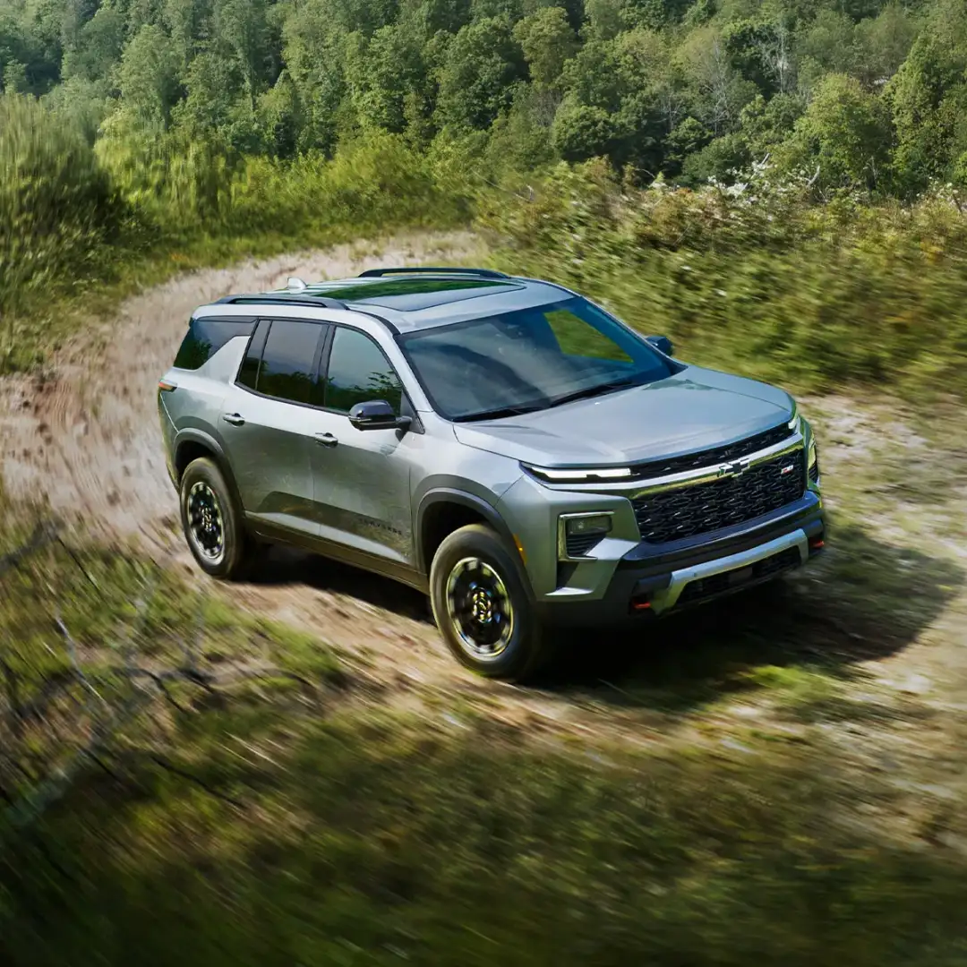 2024 Chevrolet Traverse driving through a grassy terrain