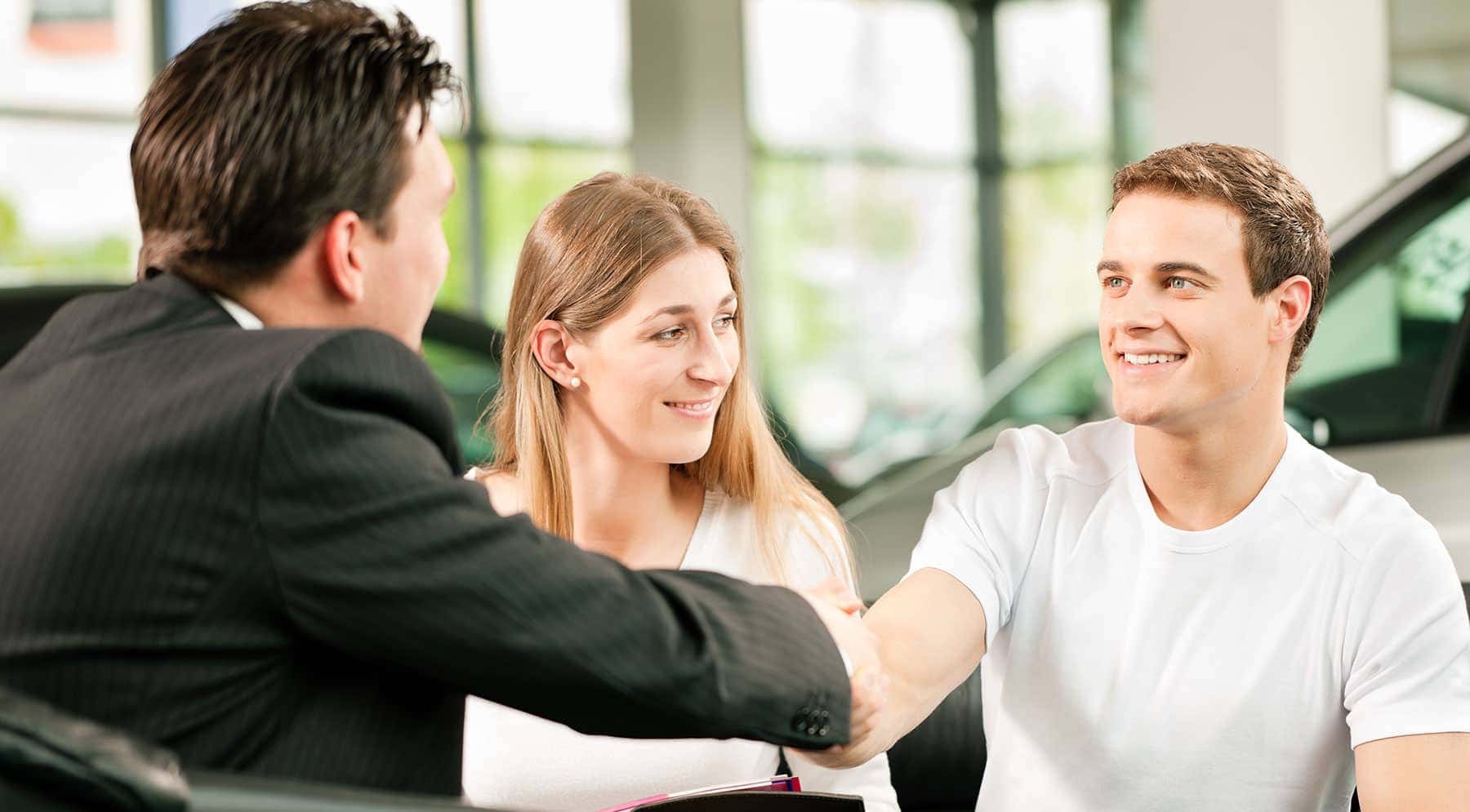 finance manager shakes couples hands