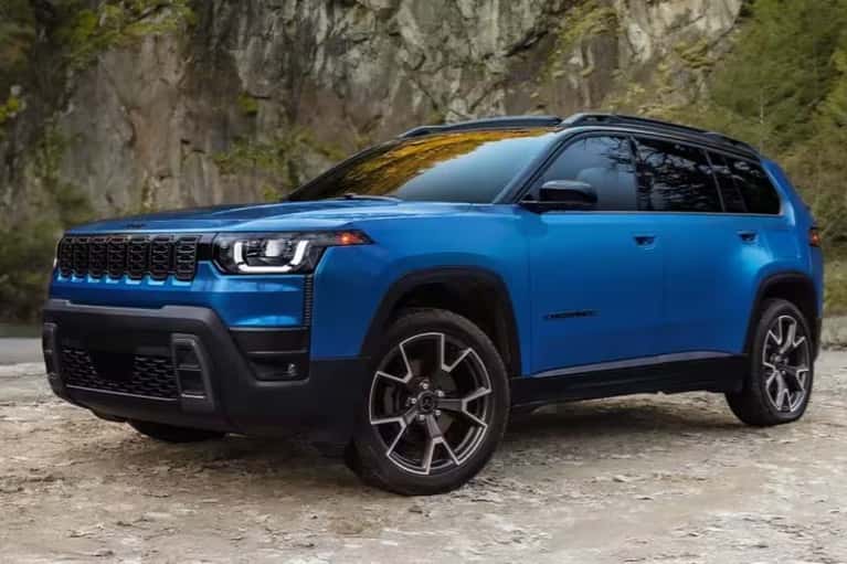 2026-jeep-cherokee-parked-by-sheer-mountain-rocks