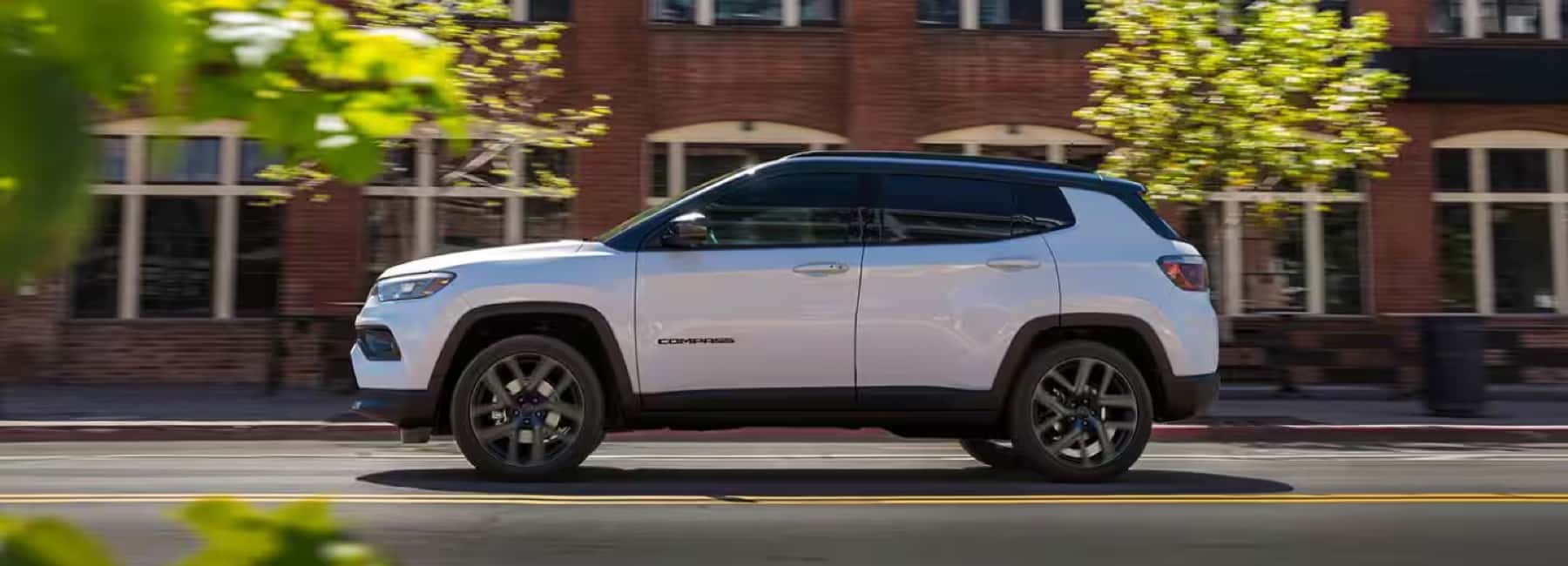2026-jeep-compas-driving-city-block
