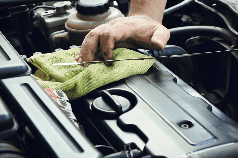 man-checks-oil-level-in-car-engine