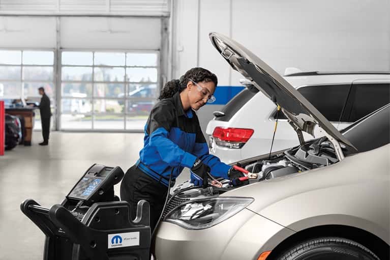 stellantis service technician examines car