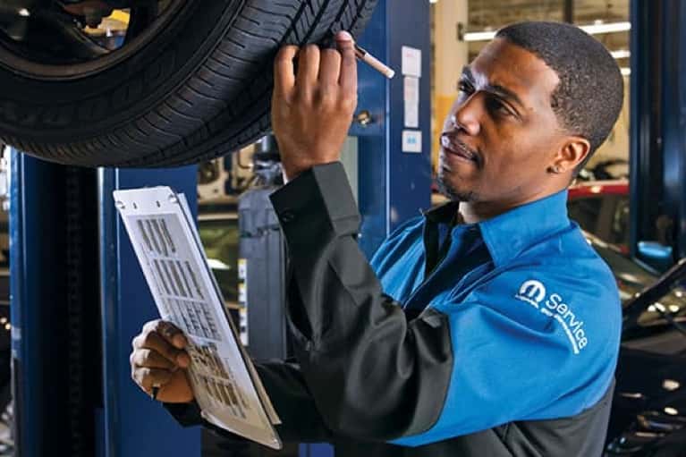stellantis service technician examines car