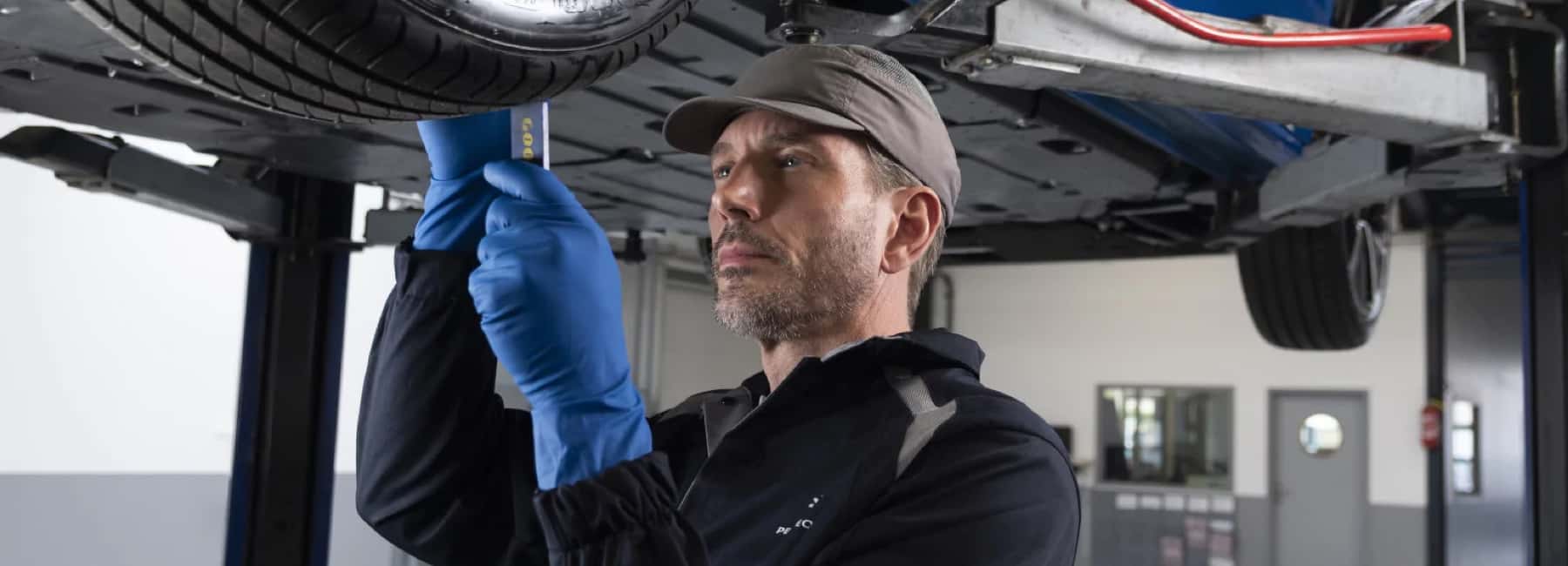stellantis-technician-works-below-car