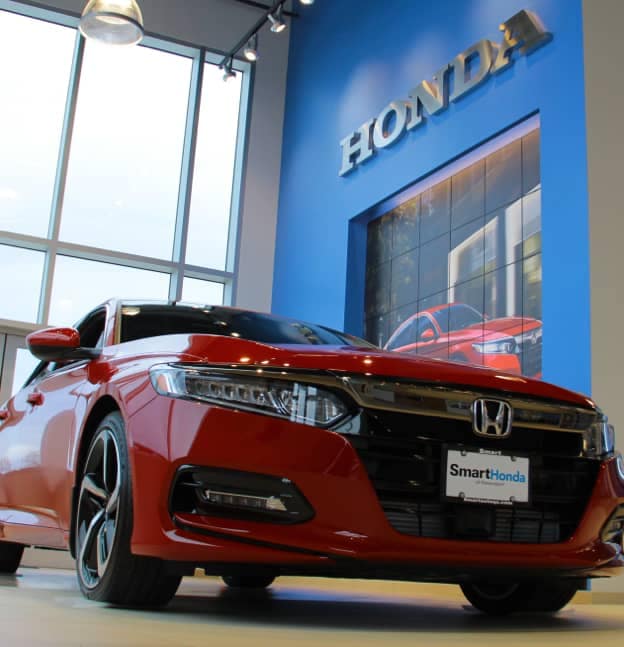 Smart Honda of Davenport showroom with red sedan