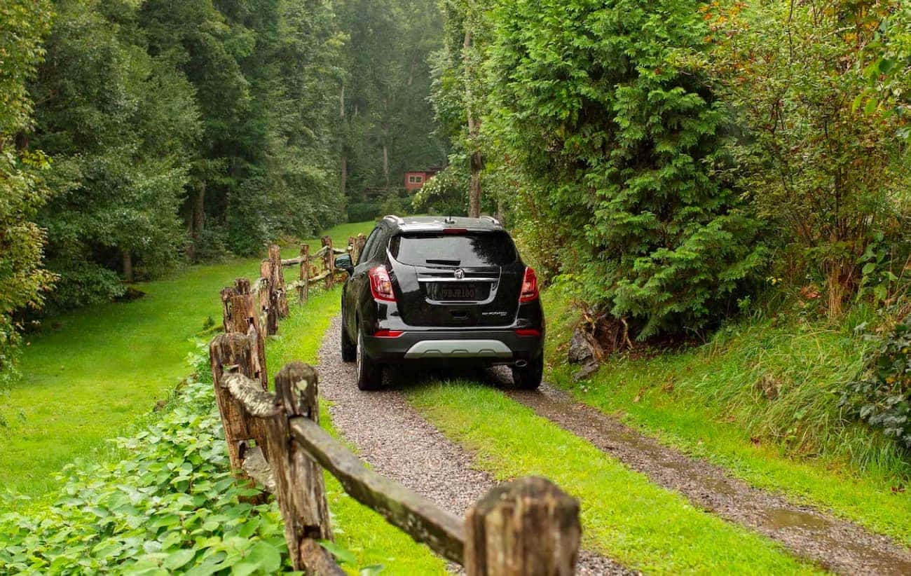 GM SUV Driving down grassy road