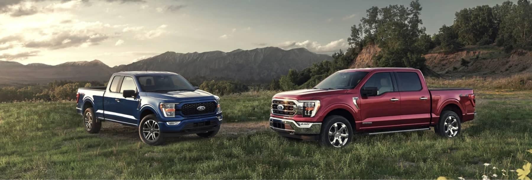 Two 2021 Ford F150 trucks in a mountain valley