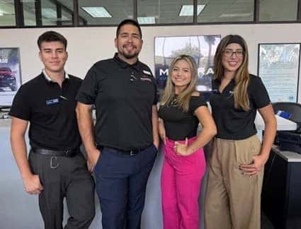 Photo of four people smiling