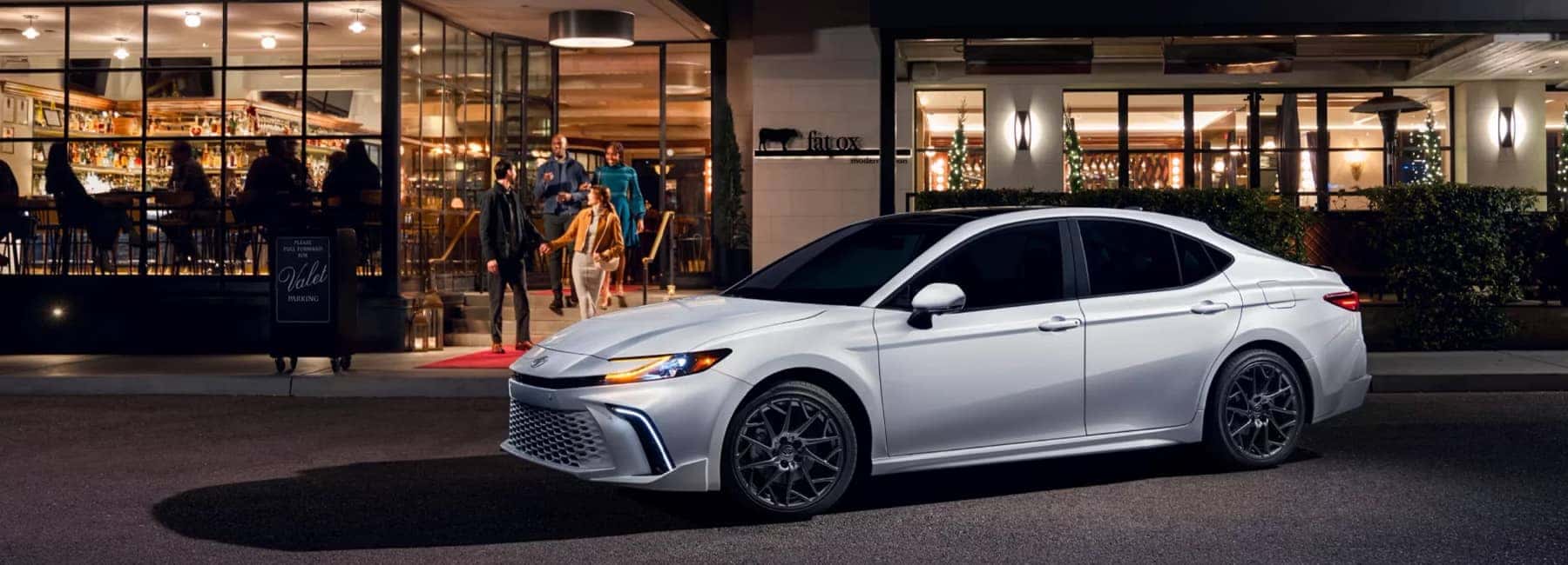 White Toyota Camry in front of a restaurant