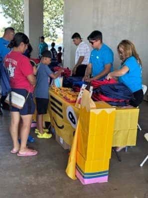 People gathered around a table during a community event