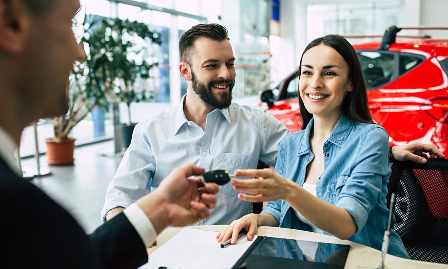 A couple talking with a car dealer