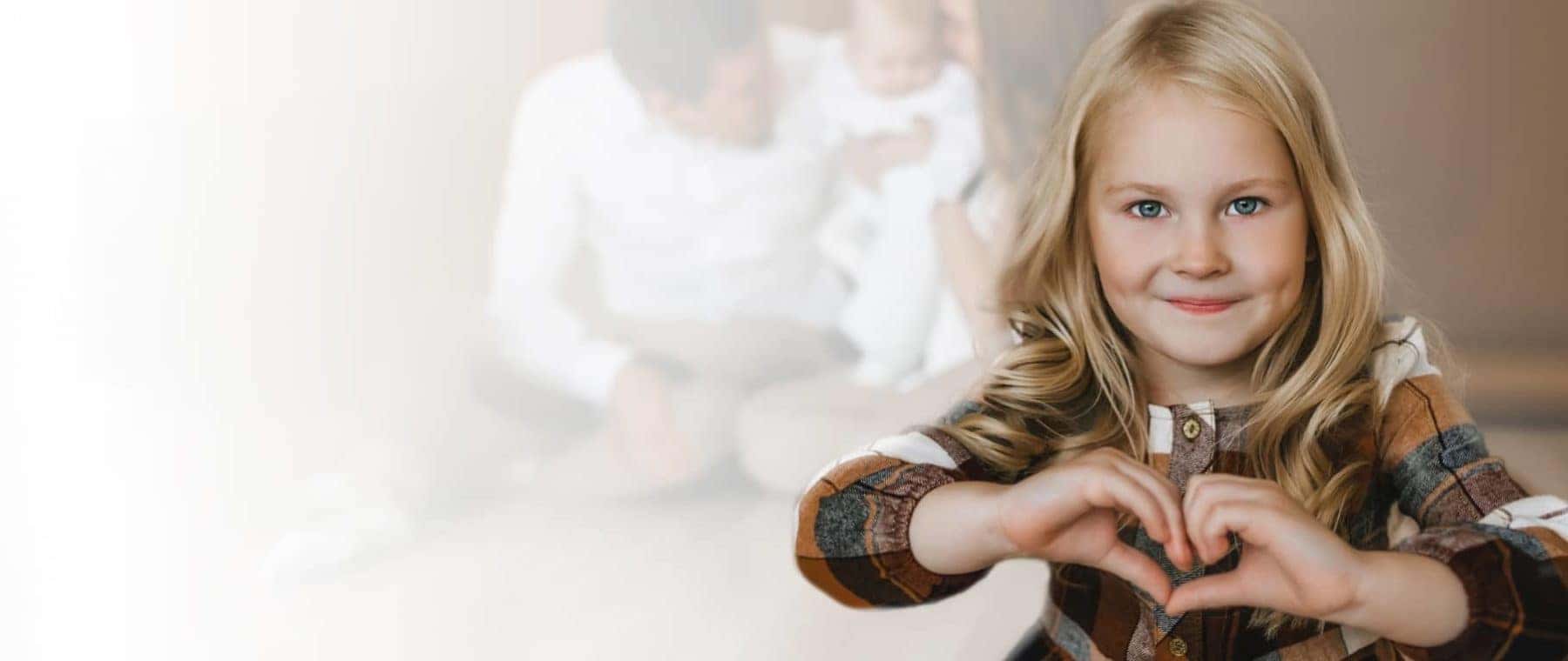 Girl making a heart symbol with her hands