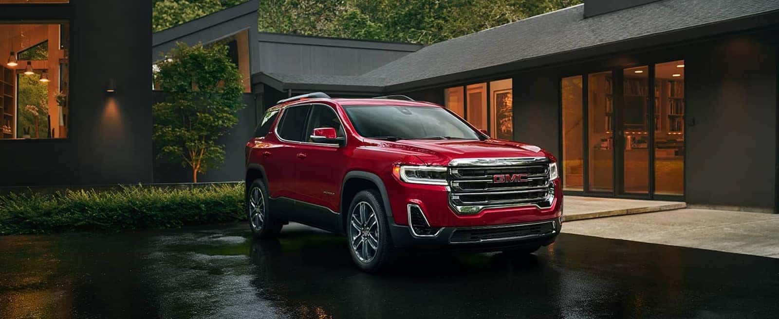 Red 2020 GMC Acadia Parked in front of a House