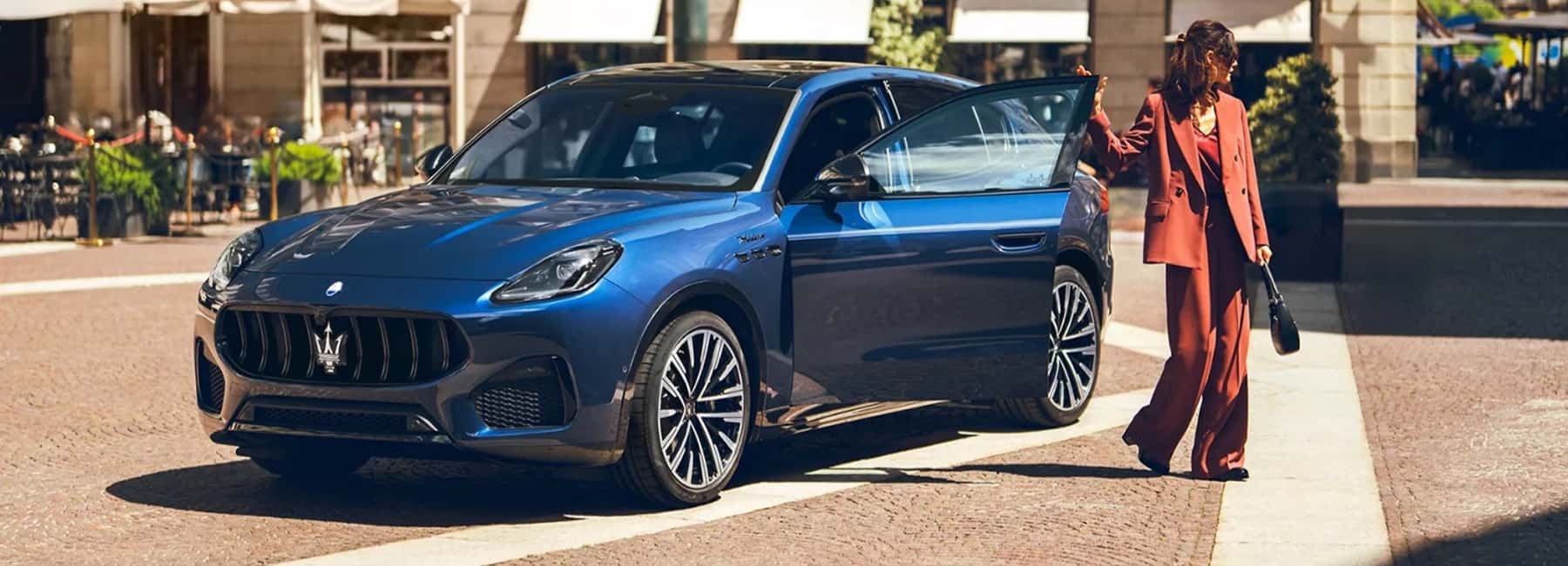 2025-maserati-grecale-woman-exits-car-in-town-plaza