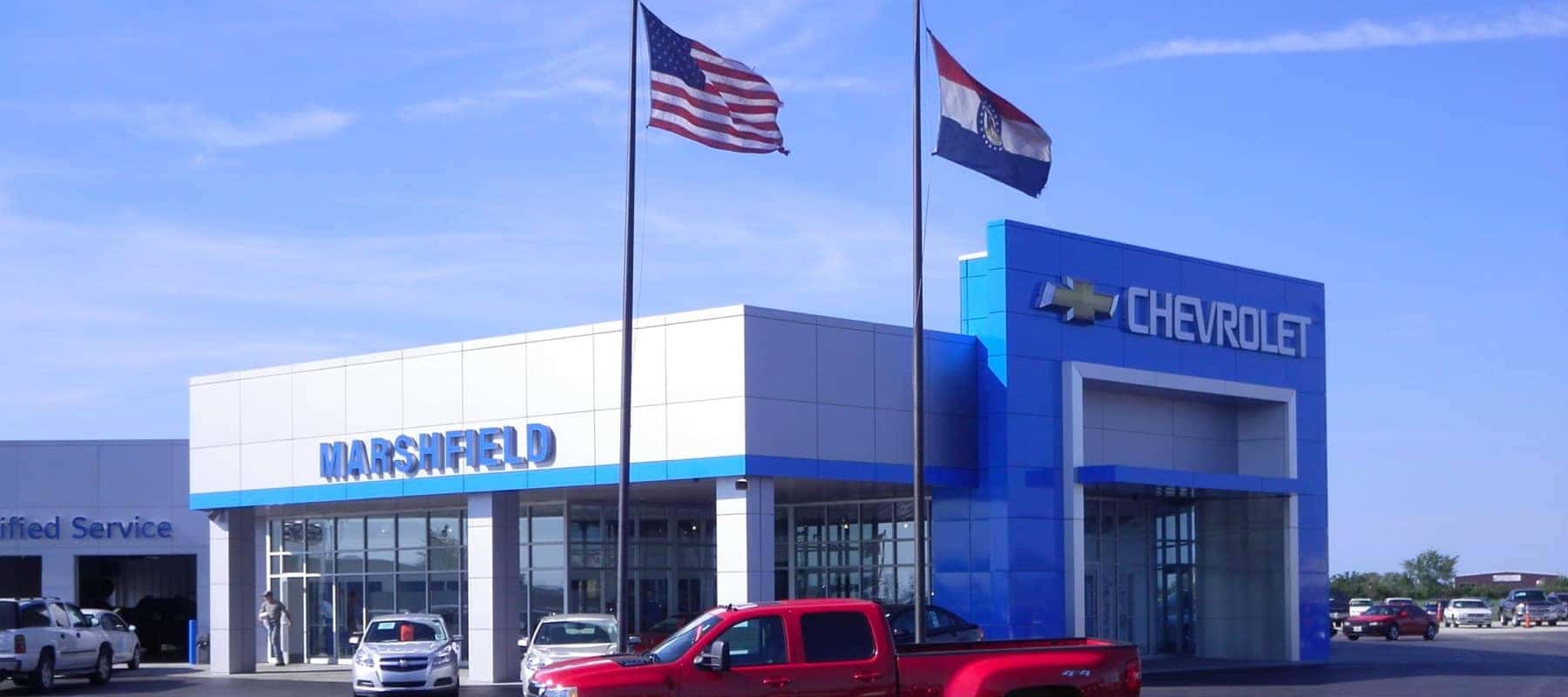 An exterior shot of a Chevrolet dealership at night.