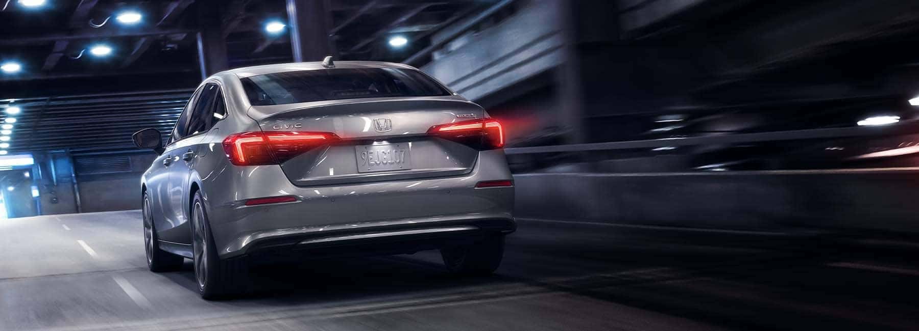 Rear view of a 2022 grey Honda Civic driving away